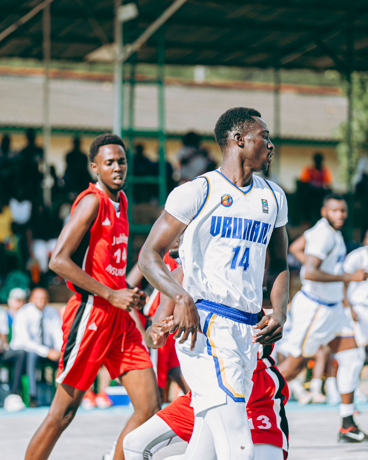 Basketball players competing on an outdoor court