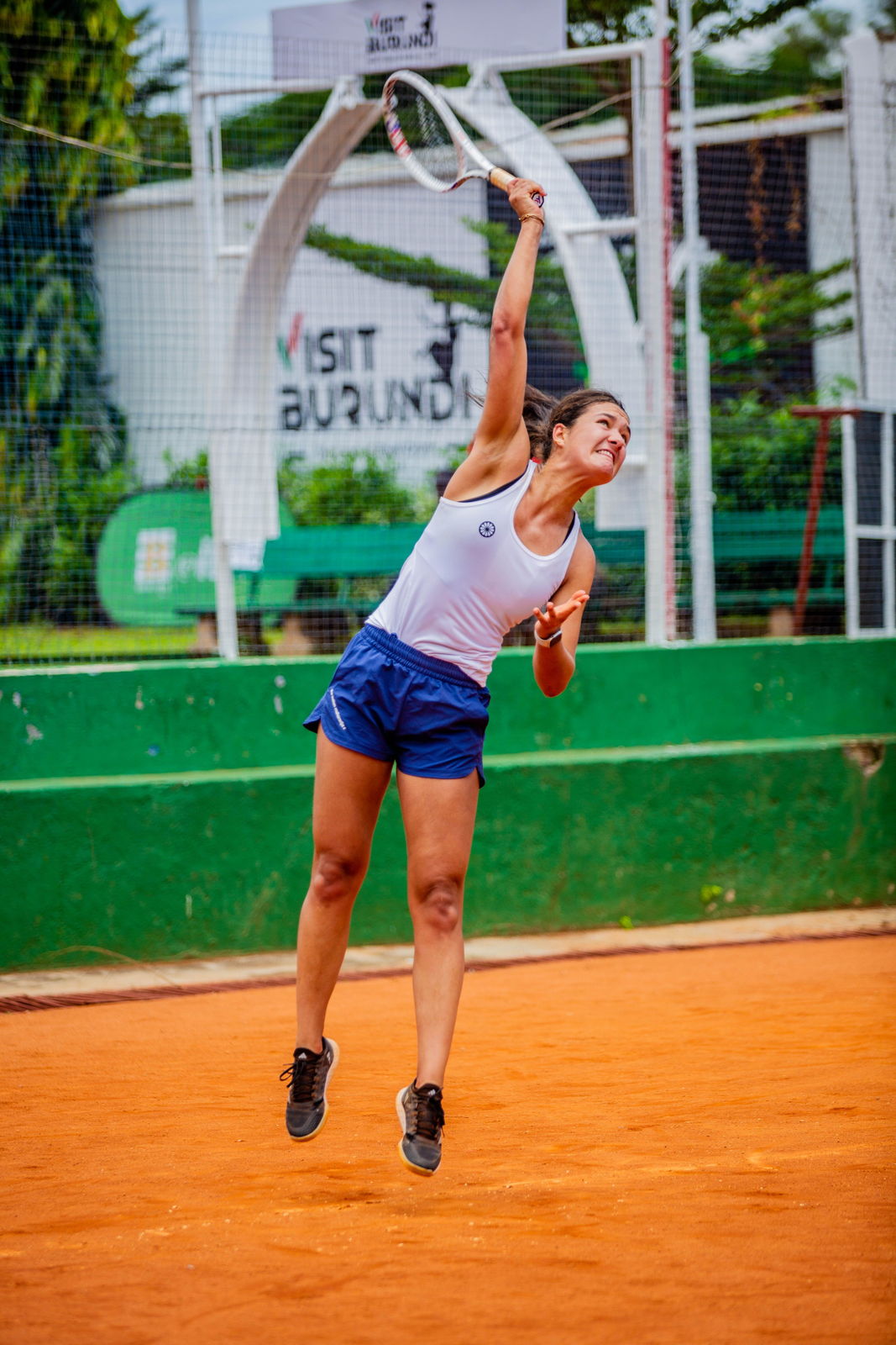 Tennis player serving on an outdoor court